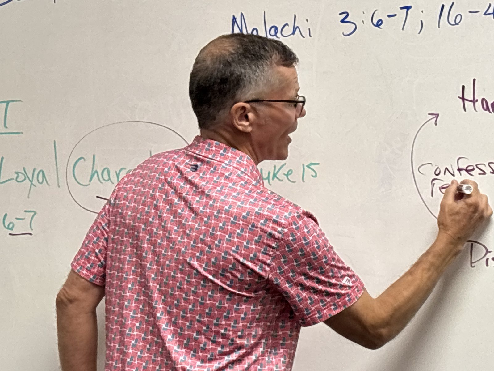 Leslie Gregory writing scripture on the whiteboard